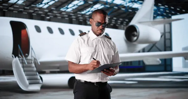 A pilot doing a walk-around check before a flight